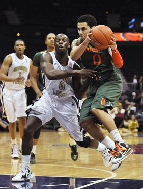 Miami guard Shane Larkin drives against Georgia Tech guard Mfon Udofia. (AP Photo/Gregory Smith)