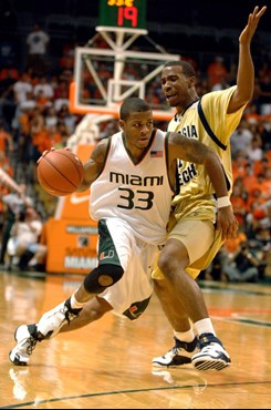 University of Miami guard Jack McClinton (33) drives past Georgia Tech guard Javaris Crittenton, right, during the first half of their basketball game...