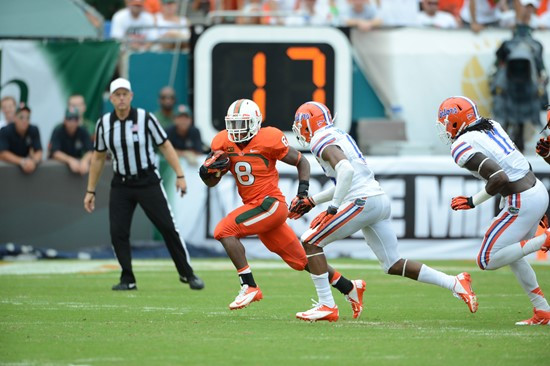 University of Miami Hurricanes running back Duke Johnson #8 plays in a game against the #12 ranked University of Florida Gators at Sun Life Stadium on...