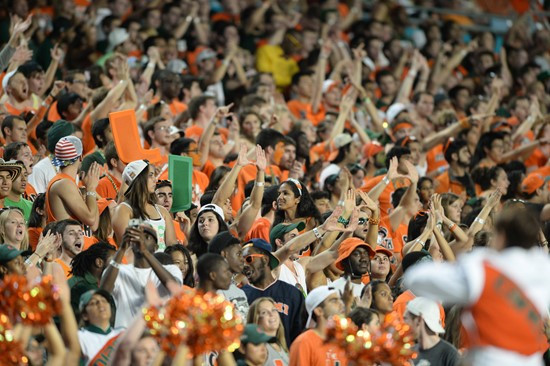 University of Miami Hurricanes fans celebrate after the Canes score a touchdown in a game against the Florida State Seminoles at Sun Life Stadium on...