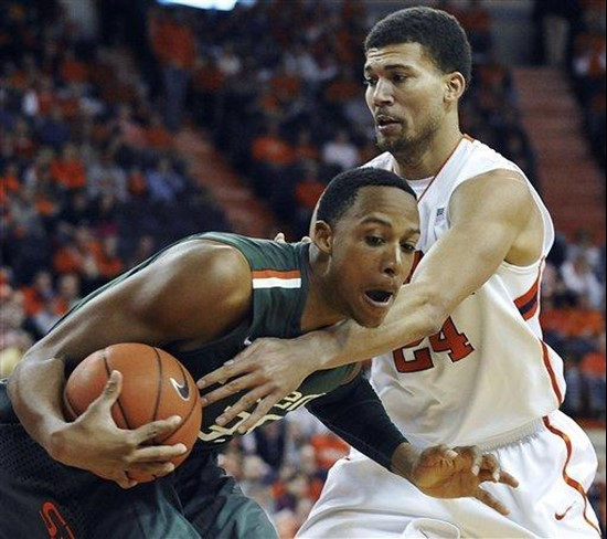 Miami's Kenny Kadji (35) drives the lane against Clemson's Milton Jennings (24) in the first half of an NCAA college basketball game, Sunday, Feb. 17,...