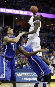 Miami guard Durand Scott, top, drives to the basket over Memphis forwards Angel Garcia (41) and Will Coleman during the first half of an NCAA college...