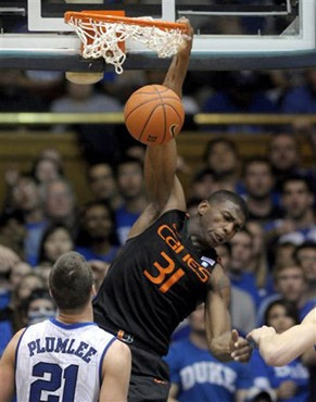 Miami's DeQuan Jones (31) dunks the ball over Duke's Miles Plumlee (21)1. (AP Photo/Sara D. Davis)