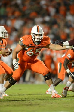 University of Miami Hurricanes offensive lineman Brandon Linder #65 gets set to block in a game against the Virginia Tech Hokies at Sun Life Stadium...