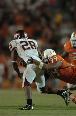 University of Miami Hurricanes defensive tackle Kareem Brown #99 tackles Virginia Tech Hokie running back Branden Ore #28 during a game which pitted...