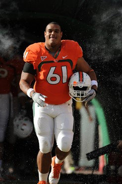 University of Miami Hurricanes offensive lineman Joel Fiqueroa #61 gets set to block in a game against the Boston College Eagles at Sun Life Stadium...