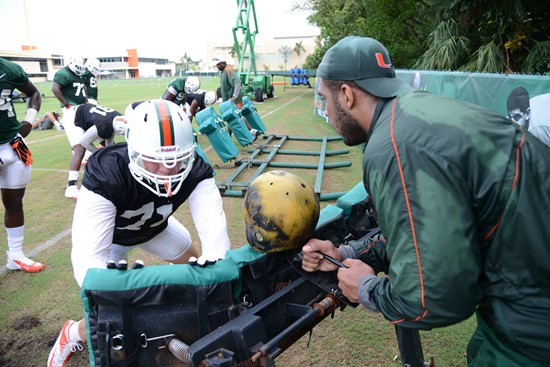 Defensive linemen hit the sleds with GA Kareem Brown