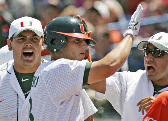 Mark Sobolewski is congratulated by teammates, including Anthony Nalepa, after scoring against Florida State on a base hit by Dennis Raben, in the...