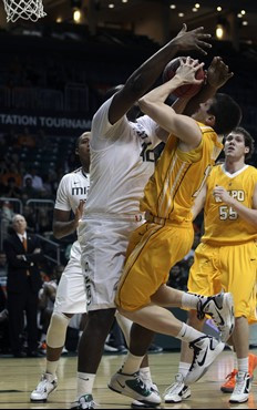 Miami's Reggie Johnson (42) blocks a shot by Valpraraiso' Nick Shelton (11) during the first half. (AP Photo/J Pat Carter)