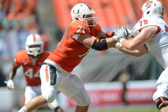 University of Miami Hurricanes defensive lineman Anthony Chickillo #71 makes a sack in a game against the North Carolina State Wolfpack at Sun Life...