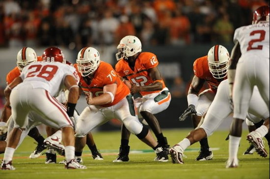 University of Miami Hurricanes quarterback Jacory Harris #12 and guard A.J. Trump #70 play in a game against the Oklahoma Sooners at Land Shark...