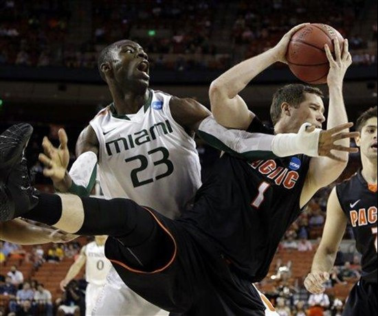Pacific's Trevin Harris (1) grabs a rebound in front of Miami's Tonye Jekiri (23) nduring the first half of a second-round game of the NCAA college...
