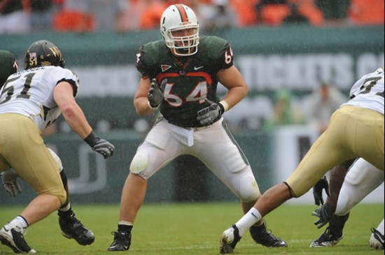 University of Miami Hurricanes offensive tackle Jason Fox #64 gets set to block in a game against the Deamon Deacons of Wake Forest at Dolphin Stadium...