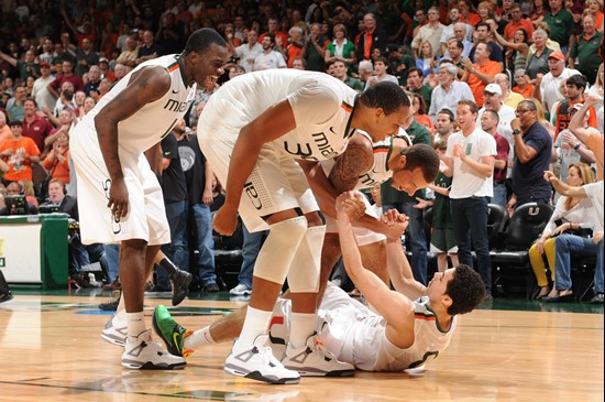 After being fouled by a Seminole, freshman Shane Larkin is congratulated by teammates Durand Scott, Kenny Kadji and Trey McKinney Jones.