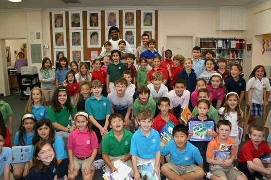 Calais Campbell and Grant Brown pose with kids from Gulliver Academy