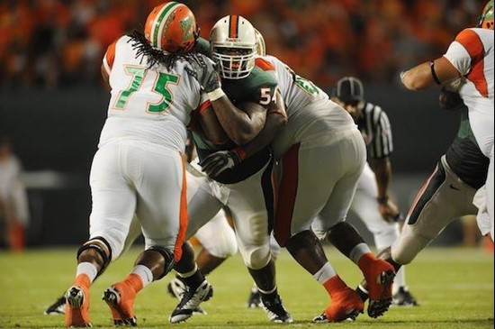 University of Miami Hurricanes defensive lineman Micanor Reqis #54 plays in a game against the Florida A&M Rattlers at Land Shark Stadium on October...