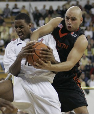 Georgia Techs' Alade Aminu, left, battles Miami guard Eddie Rios for a rebound during the first half of a basketball game Sunday, Feb. 17, 2008, in...