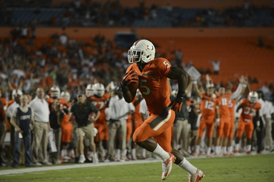 University of Miami Hurricanes running back Mike James #5 carries the ball against the Virginia Tech Hokies at Sun Life Stadium on November 1, 2012. ...