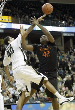 Miami's Reggie Johnson (42) is fouled by Wake Forest's Ty Walker (40) during the second half of Miami's 74-73 win in an NCAA college basketball game...