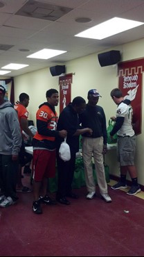 Seven football players and other staff delivered 48 turkey dinners to the Greater Mercy Missionary Baptist Church in Overtown.