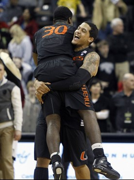 Miami's Julian Gamble, right, lifts teammate Adrian Thomas after Miami's 74-73 win over Wake Forest in an NCAA college basketball game in...