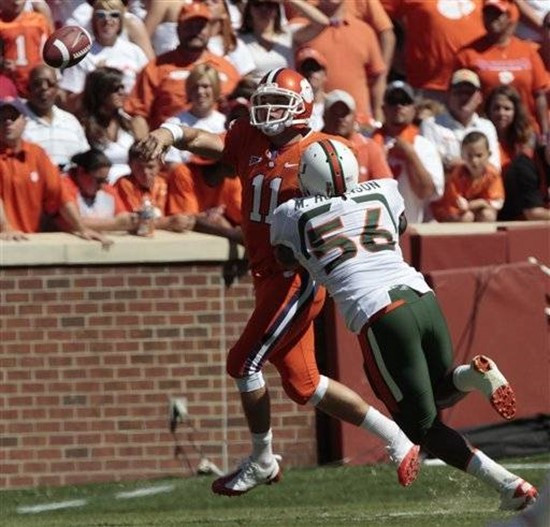 Miami's Marcus Robinson puts pressure on Clemson's Kyle Parker as her tries to throw during the second quarter of an NCAA college football game in...