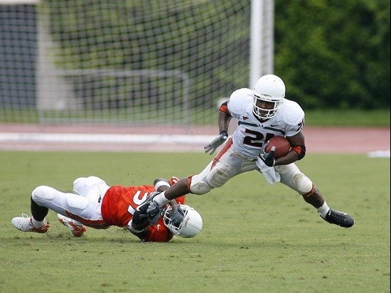 Junior running back Derron Thomas tries to break out of the grasp of defensive back Jared Campbell.