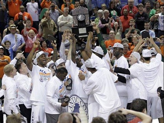 Miami players raise the trophy after winning the Atalntic Coast Conference tournament at an NCAA college basketball game against North Carolina in...