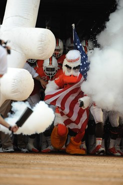 Sebastian the Ibis leads the University of Miami Hurricanes through a tunnel of smoke in a game against the Kansas State Wildcats at Sun Life Stadium...