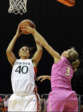 Miami's Shawnice Wilson, left, is defended by Florida State's Alexa Deluzio, right, during the first half of an NCAA college basketball game on...