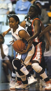 North Carolina's Alex Miller (11) is pressured by Miami's Charmaine Clark, right, for a loose ball during the first half of a college basketball game...