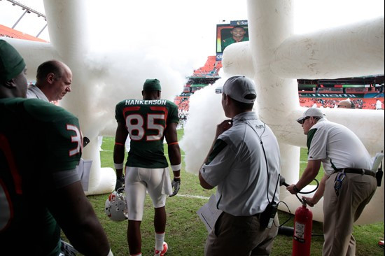 University of Miami Hurricanes wide receiver Leonard Hankerson #85 runs through a tunnel of smoke as the seniors are introduced before playing their...