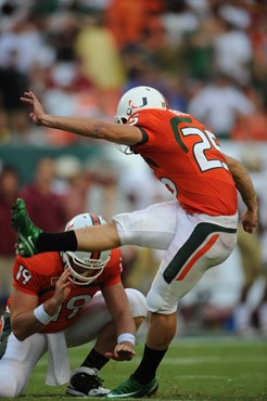University of Miami Hurricanes kicker/punter Matt Bosher #25 kicks in a game against The Florida State Seminoles at Dolphin Stadium on October 4,...