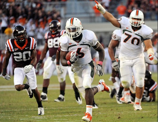 Miami's Lamar Miller (6) runs for a touchdown while pursued by Virginia Tech's Jayron Hosley (20) during the second half of an NCAA college football...