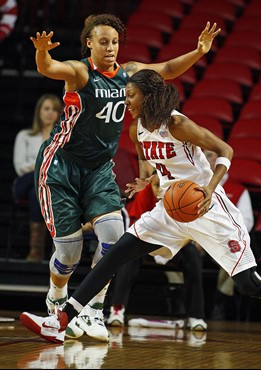 Miami's Shawnice Wilson (40) defends North Carolina State's Tia Bell (4) during the first half. (AP Photo/Karl B DeBlaker)