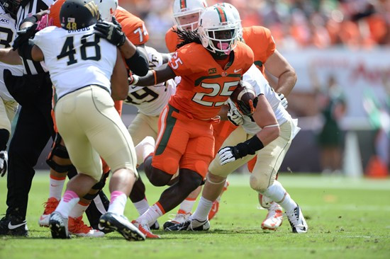 University of Miami Hurricanes running back Dallas Crawford #25 carries the ball in a game against the Wake Forest Demon Deacons at Sun Life Stadium...