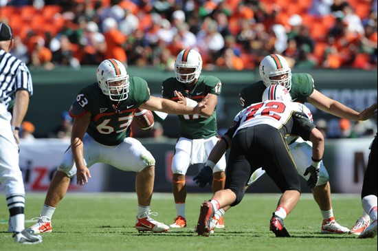 University of Miami Hurricanes offensive lineman Tyler Horn #63 gets set to block in a game against the Maryland Terrapins at Sun Life Stadium on...