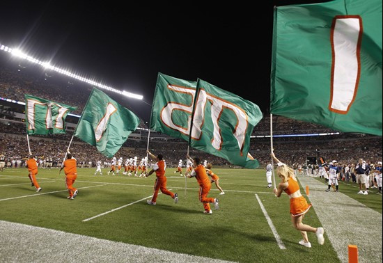 The Miami cheerleaders carry a series of flags spelling "Miami" across the end zone after Miami a touchdown against Pittsburgh in the first quarter of...