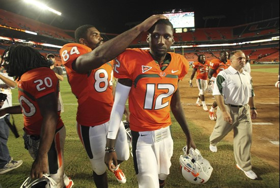 Miami tight end Richard Gordon (84) rubs the head of quarterback Jacory Harris after Miami defeated Florida A&amp;M 45-0 in an NCAA college football...