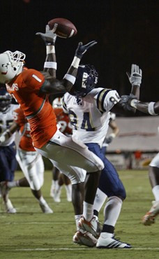 Miami safety Kenny Phillips, left, intercepts a pass intended for Florida International wide receiver Elliott Dix during the first quarter of a...