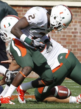 Miami running back Graig Cooper (2) loses the ball during the first half of an NCAA college football game against Virginia at Scott Stadium in...