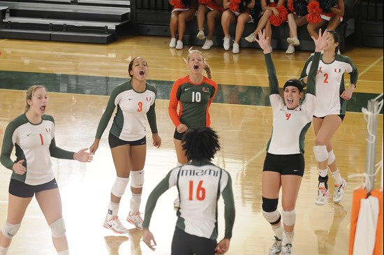 The Hurricanes celebrate winning a big point coming together in the middle of the court at the Knight Sports Complex.