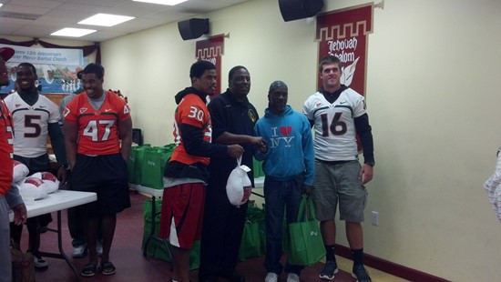 Seven football players and other staff delivered 48 turkey dinners to the Greater Mercy Missionary Baptist Church in Overtown.
