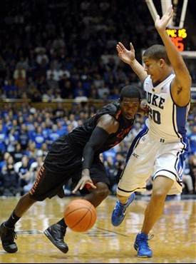 Miami's Malcolm Grant, left, drives into Duke's Andre Dawkins (20). Duke won 74-63 over Miami. (AP Photo/Sara D. Davis)